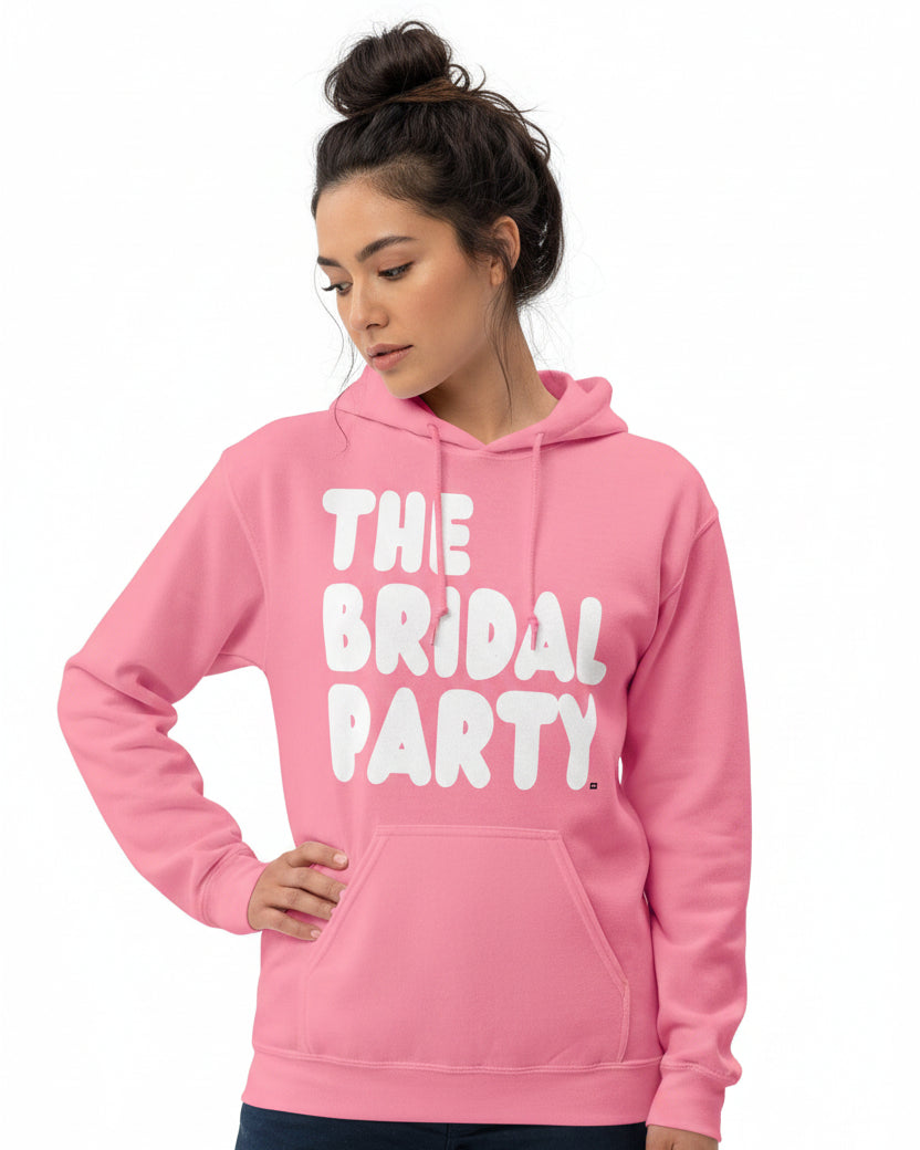Woman wearing The APWT Gift Shop's the Bridal Party Unisex Hoodie from the APWT Wedding Shop in Pink