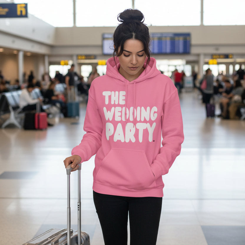 Woman wearing the APWT Gift Shop's The Wedding Party Unisex Hoodie from the APWT Wedding Shop in Pink
