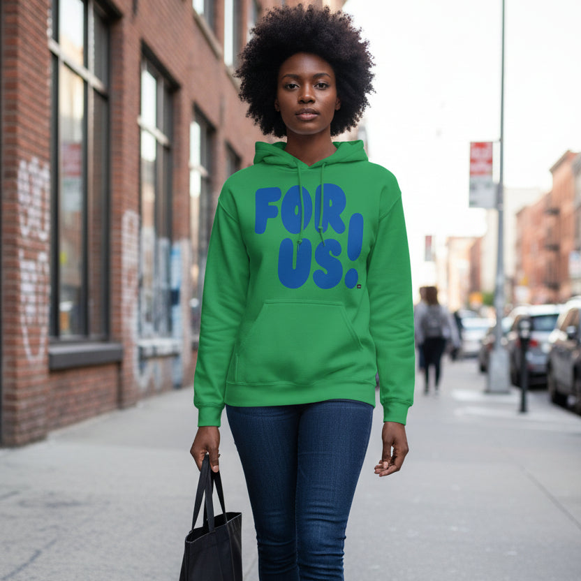 Woman walking down a city sidewalk wearing the APWT Gift Shop's For Us in Green and Blue Unisex Hoodie from the For Us Collection
