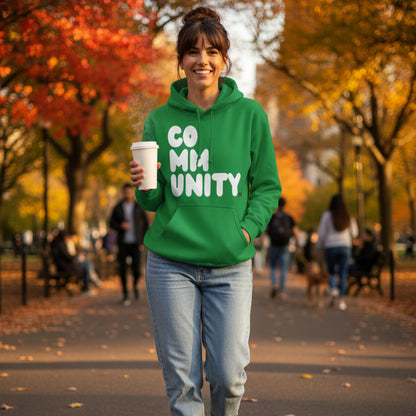 Woman walking through the park wearing the APWT Gift Shop's A Community in Green Grass Unisex Hoodie from the Community Collection
