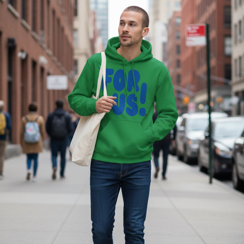 Man walking down a city sidewalk wearing the APWT Gift Shop's For Us in Green and Blue Unisex Hoodie from the For Us Collection