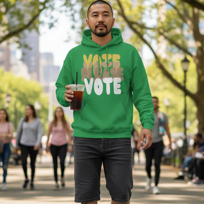 Man walking through a city park wearing the APWT Gift Shop's Please Vote in Green Spaces Unisex Hoodie from the APWT Vote Shop