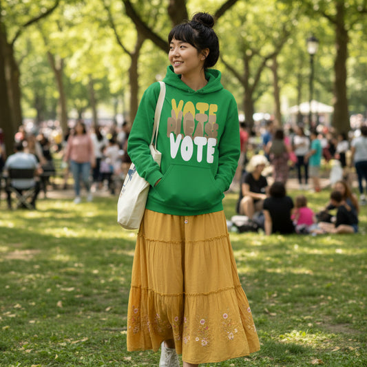 Woman wearing Please Vote in Green Spaces Unisex Hoodie from the APWT Gift Shop -  Vote Advocacy Sweatshirt