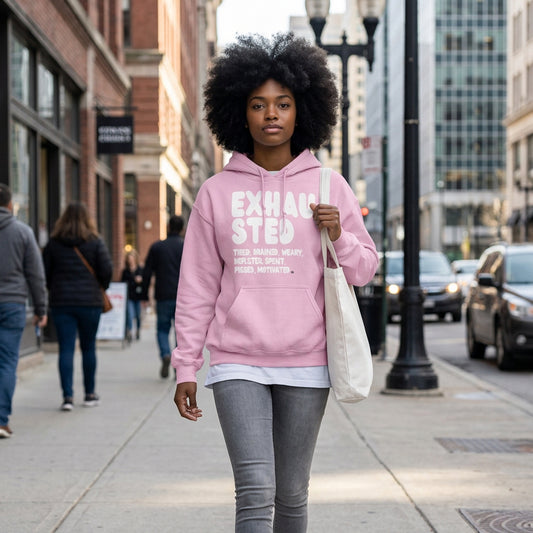 Woman walking down the street wearing The APWT Gift Shop's Exhausted in Pink Unisex Hoodie from the Exhausted Collection