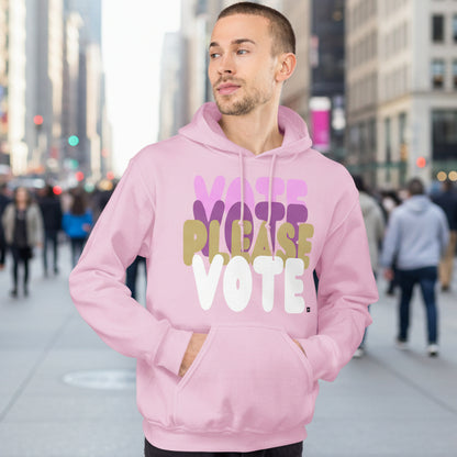 Man on a city street wearing Please Vote in Primaries Pink Unisex Hoodie from the APWT Gift Shop -  Vote Advocacy Sweatshirt