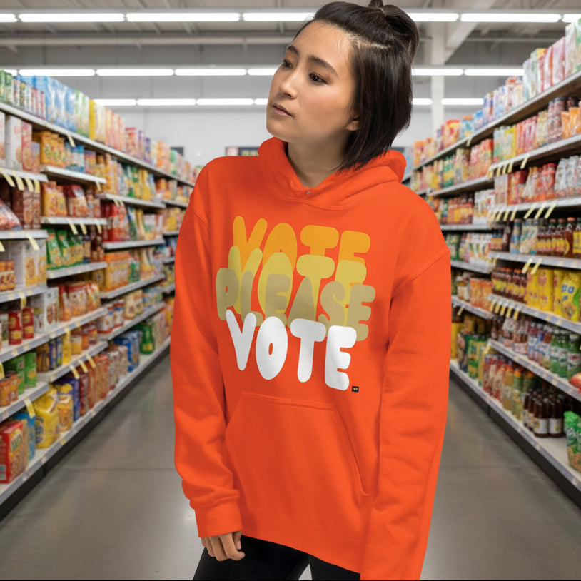 Woman in Supermarket Wearing Please Vote in Safety Cone Orange Unisex Hoodie from the APWT Gift Shop -  Vote Advocacy Sweatshirt