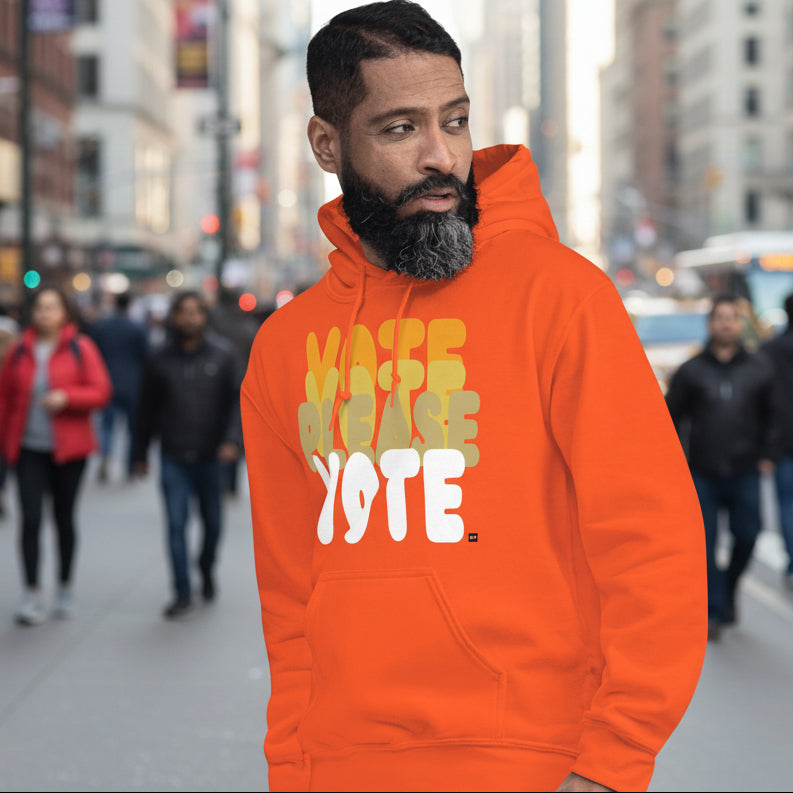 Man on street wearing Please Vote in Safety Cone Orange Unisex Hoodie from the APWT Gift Shop -  Vote Advocacy Sweatshirt
