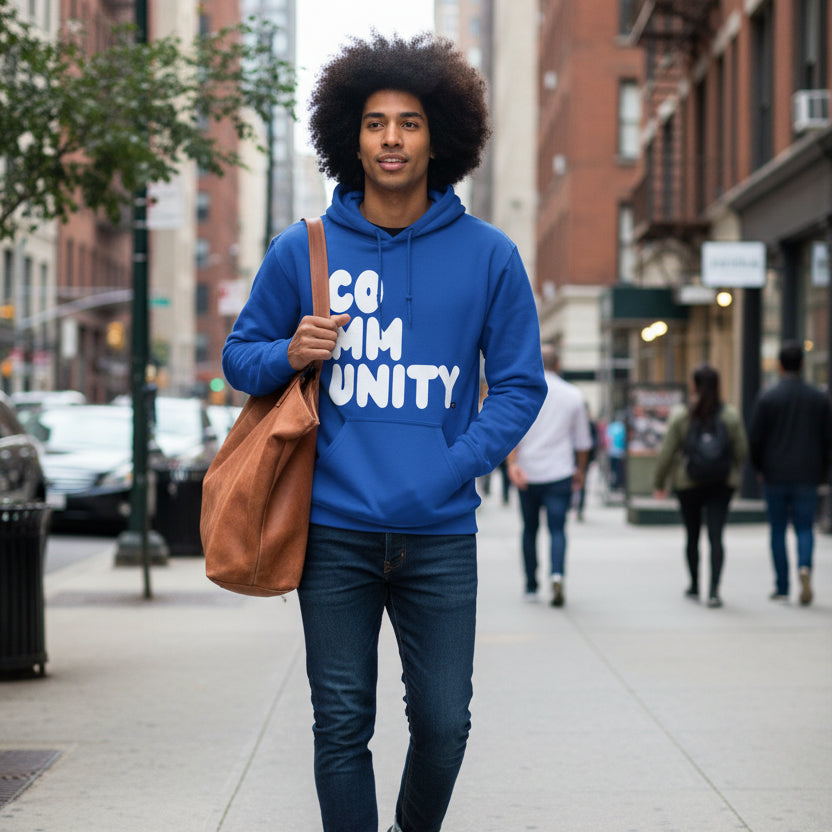 Man walking down the street wearing the APWT Gift Shop's A Community in Ocean Blue Unisex Hoodie from the Community Collection
