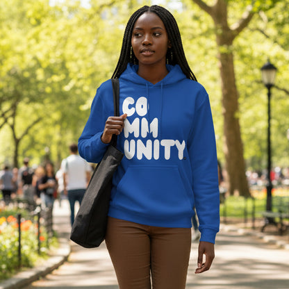 Woman walking through the park wearing the APWT Gift Shop's A Community in Ocean Blue Unisex Hoodie from the Community Collection