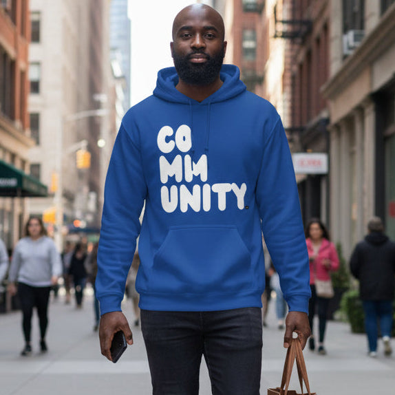 Man walking down the street wearing the APWT Gift Shop's A Community in Ocean Blue Unisex Hoodie from the Community Collection