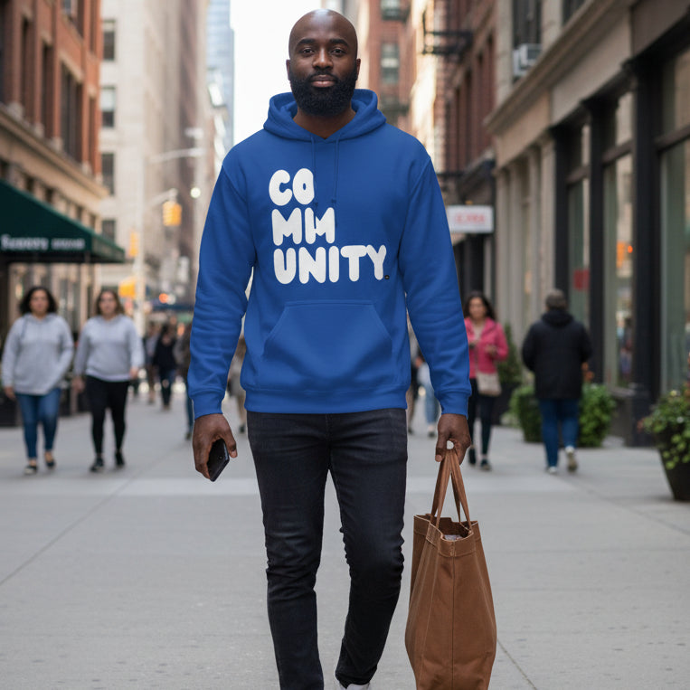 Man walking down the street wearing the APWT Gift Shop's A Community in Ocean Blue Unisex Hoodie from the Community Collection