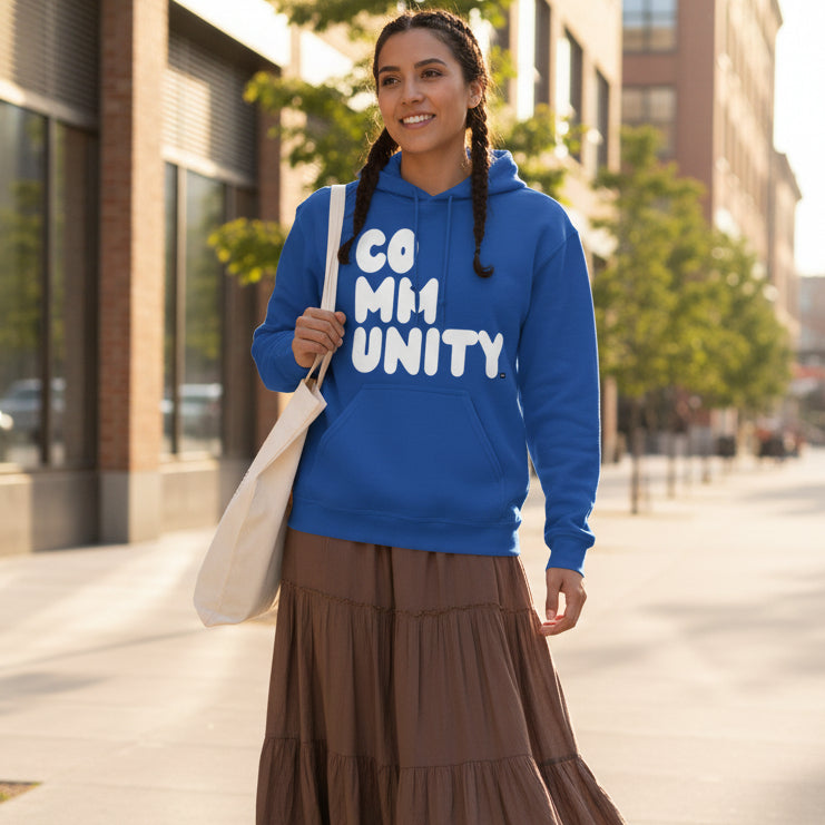 Woman walking down the street wearing the APWT Gift Shop's A Community in Ocean Blue Unisex Hoodie from the Community Collection