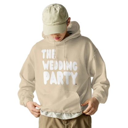 Man wearing the APWT Gift Shop's The Wedding Party Unisex Hoodie from the APWT Wedding Shop in beige