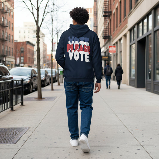 Man walking down the street wearing the APWT Gift Shop's Please Vote Unisex Zip-Up Hoodie from the APWT Vote Shop in Navy Blue