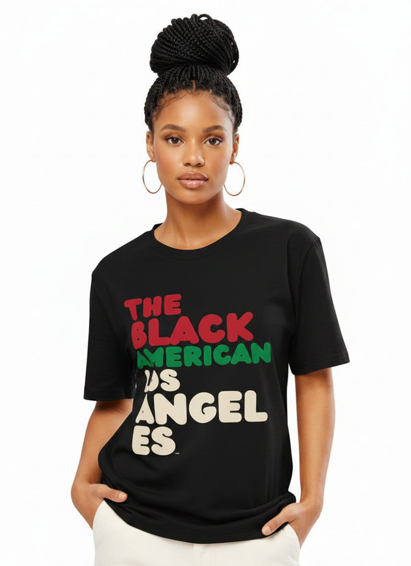 Woman wearing the APWT Gift Shop's The Black American Los Angeles Premium Unisex T-Shirt from the Black Collection
