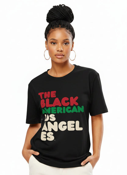 Woman wearing the APWT Gift Shop's The Black American Los Angeles Premium Unisex T-Shirt from the Black Collection
