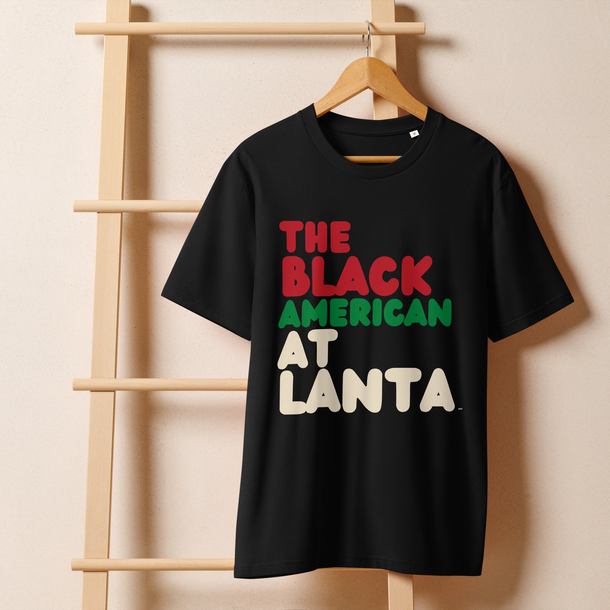The Black American Atlanta Premium Unisex T-Shirt on a hanger