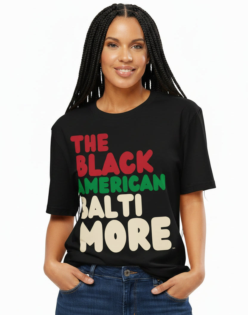 Woman wearing The APWT Gift Shop's the Black American Baltimore Premium Unisex T-Shirt from the Black Collection