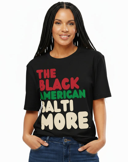 Woman wearing The APWT Gift Shop's the Black American Baltimore Premium Unisex T-Shirt from the Black Collection