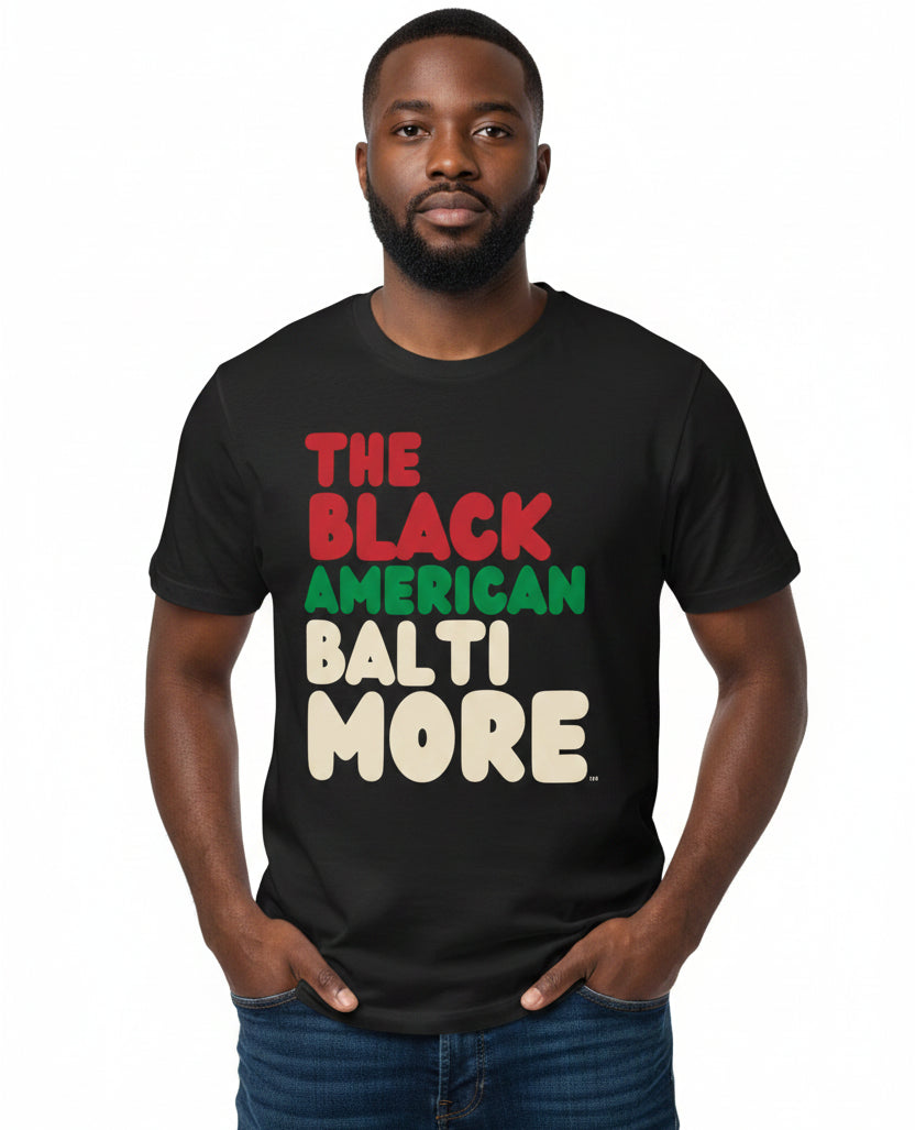 Man wearing The APWT Gift Shop's the Black American Baltimore Premium Unisex T-Shirt from the Black Collection