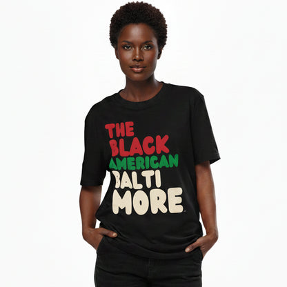 Woman wearing The APWT Gift Shop's the Black American Baltimore Premium Unisex T-Shirt from the Black Collection
