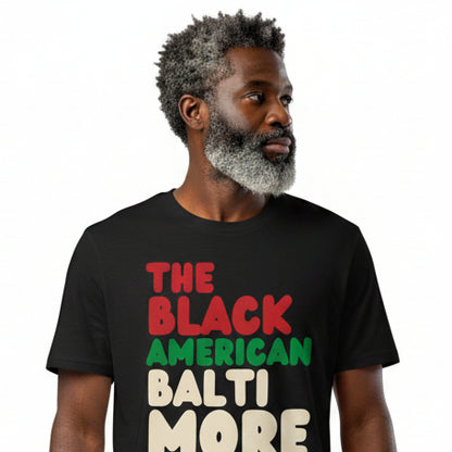 Man wearing The APWT Gift Shop's the Black American Baltimore Premium Unisex T-Shirt from the Black Collection