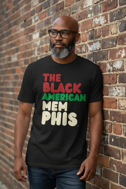 Man wearing a black t-shirt with 'THE BLACK AMERICAN MEMPHIS' text in red, green, and beige on a white background.