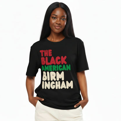 Woman wearing the APWT Gift Shop's the Black American Birmingham Premium Unisex T-Shirt from the Black Collection