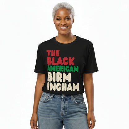 Woman wearing the APWT Gift Shop's the Black American Birmingham Premium Unisex T-Shirt from the Black Collection