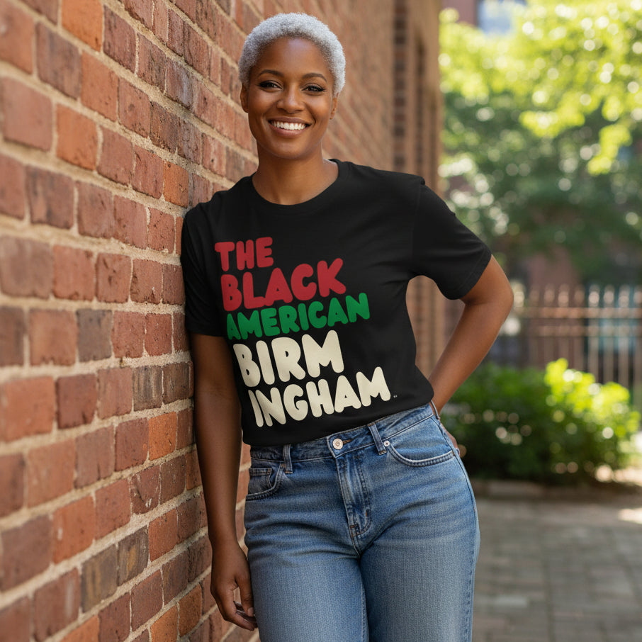 Woman wearing the APWT Gift Shop's the Black American Birmingham Premium Unisex T-Shirt from the Black Collection