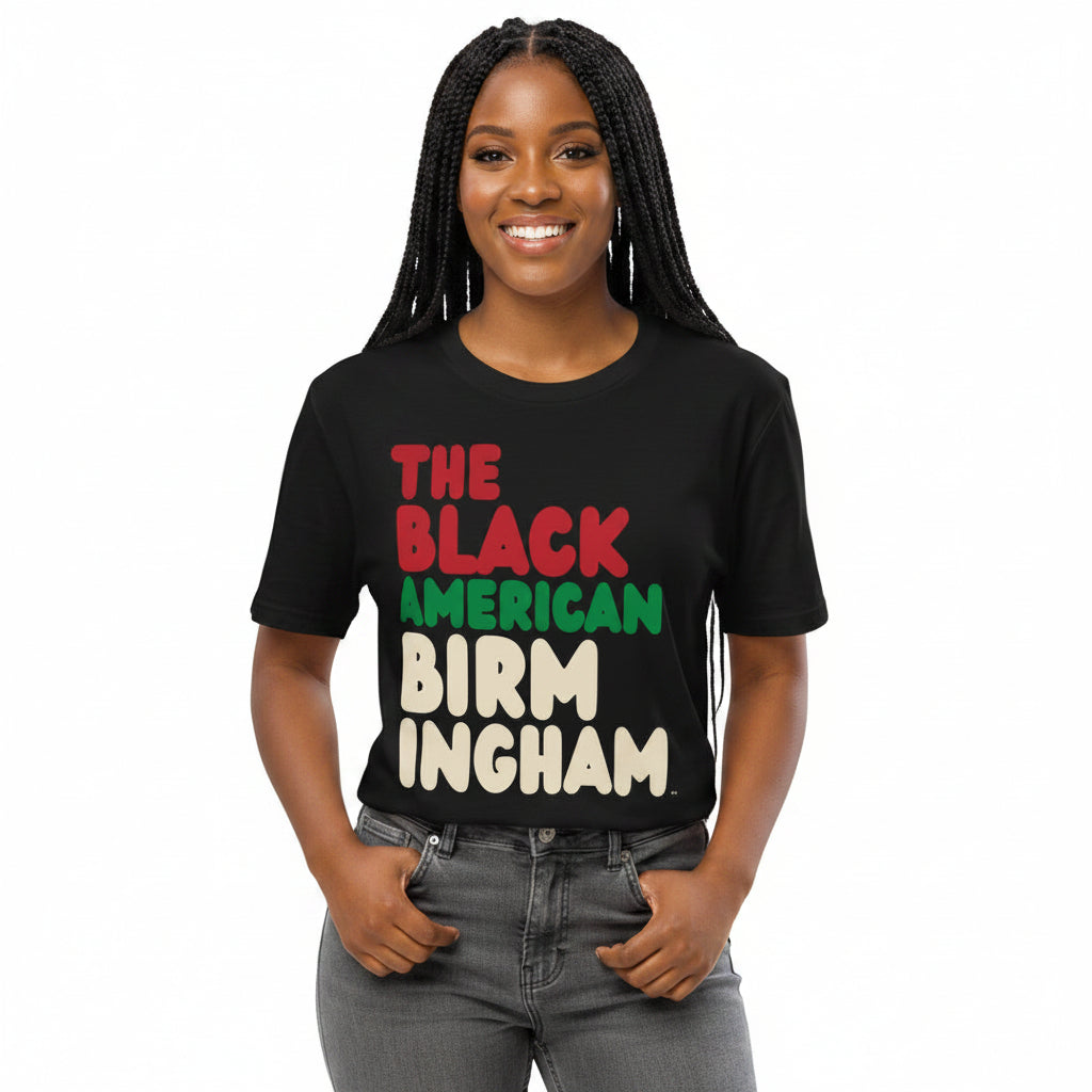 Woman wearing the APWT Gift Shop's the Black American Birmingham Premium Unisex T-Shirt from the Black Collection