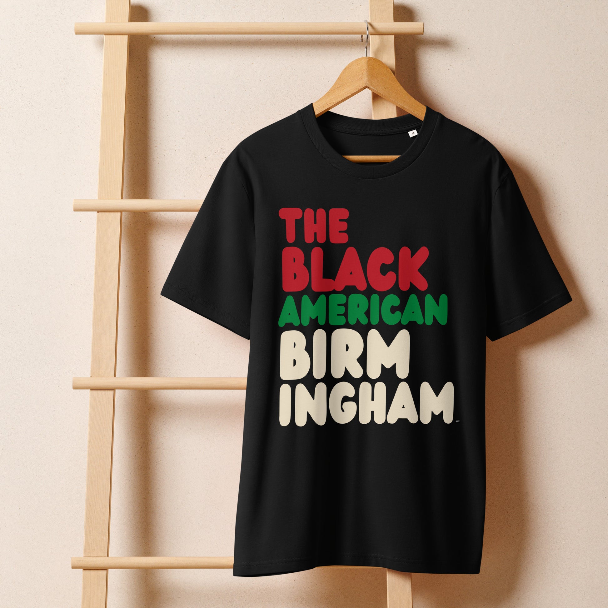 The APWT Gift Shop's the Black American Baltimore Premium Unisex T-Shirt from the Black Collection
