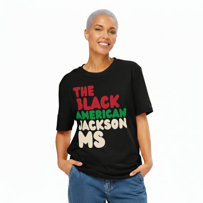 Woman wearing the APWT Gift Shop's the Black American Jackson MS Premium Unisex T-Shirt from the Black Collection
