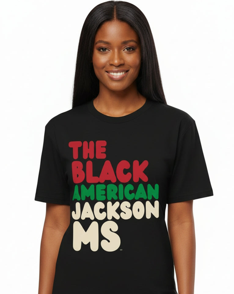 Woman wearing the APWT Gift Shop's the Black American Jackson MS Premium Unisex T-Shirt from the Black Collection