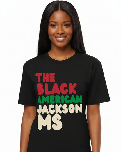 Woman wearing the APWT Gift Shop's the Black American Jackson MS Premium Unisex T-Shirt from the Black Collection