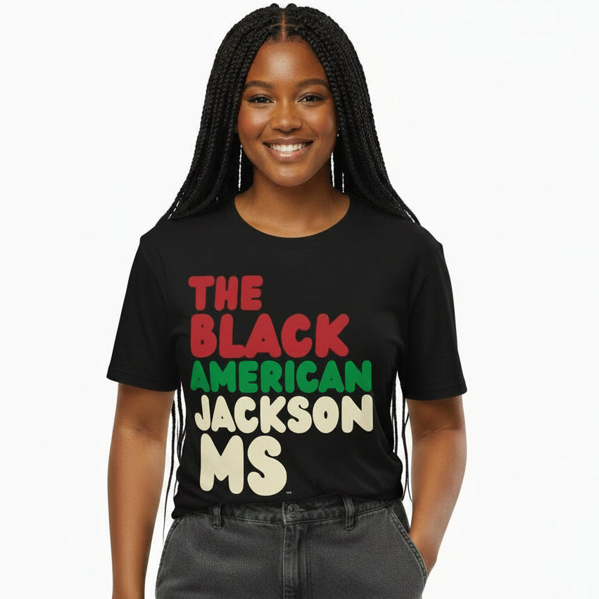 Woman wearing the APWT Gift Shop's the Black American Jackson MS Premium Unisex T-Shirt from the Black Collection
