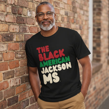Man wearing the APWT Gift Shop's the Black American Jackson MS Premium Unisex T-Shirt from the Black Collection
