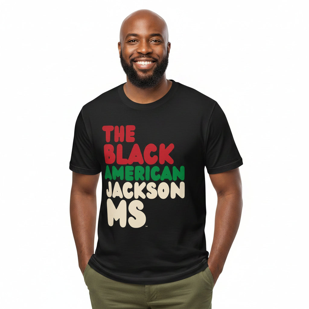 Man wearing the APWT Gift Shop's the Black American Jackson MS Premium Unisex T-Shirt from the Black Collection