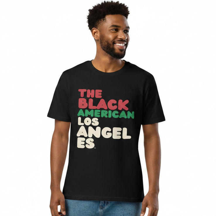 Man wearing the APWT Gift Shop's The Black American Los Angeles Premium Unisex T-Shirt from the Black Collection