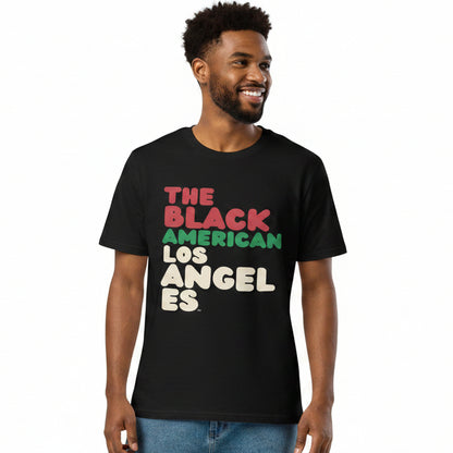 Man wearing the APWT Gift Shop's The Black American Los Angeles Premium Unisex T-Shirt from the Black Collection