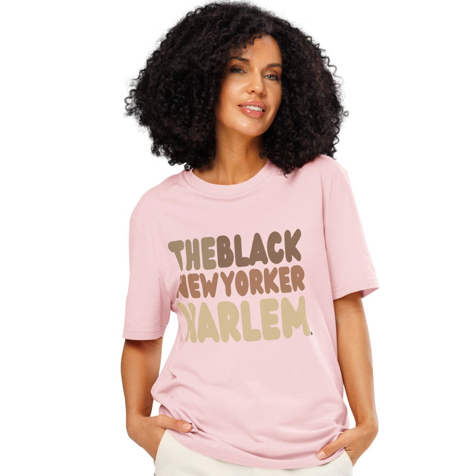 Woman wearing The Black NewYorker Harlem Premium Unisex T-Shirt in Pink