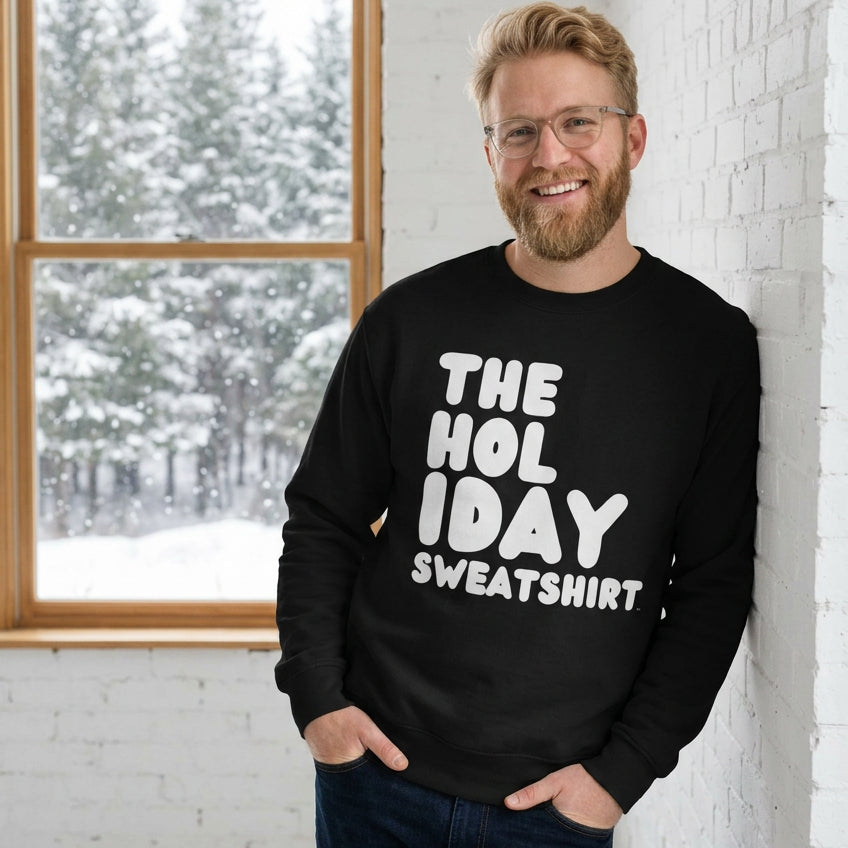Man wearing the Holiday Celebration Premium Unisex Crew Neck Sweatshirt from the APWT Holiday Shop and the Premium Basics Collection