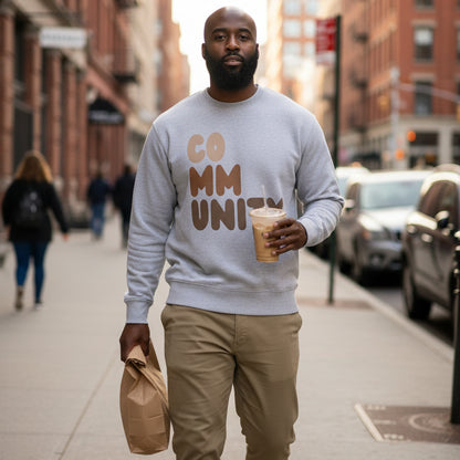 man walking down a city street wearing the APWT Gift Shop's Our Community Premium Unisex Crew Neck Sweatshirt from the Community Collection and the Premium Basics Collection in Grey