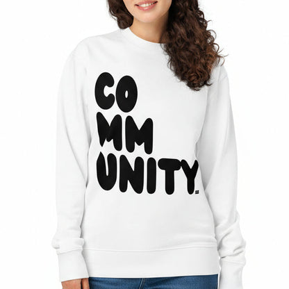 Woman wearing a white sweatshirt with 'COMMUNITY' printed on it against a white background