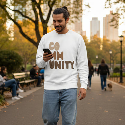 man walking through a city park wearing the APWT Gift Shop's Our Community Premium Unisex Crew Neck Sweatshirt from the Community Collection and the Premium Basics Collection in White