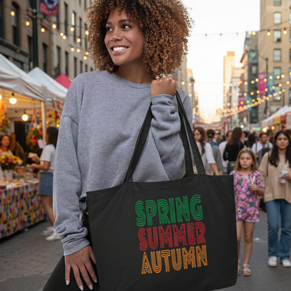 woman holding The Spring into Summer Jumbo Tote Bag from the APWT Gift Shop in Black